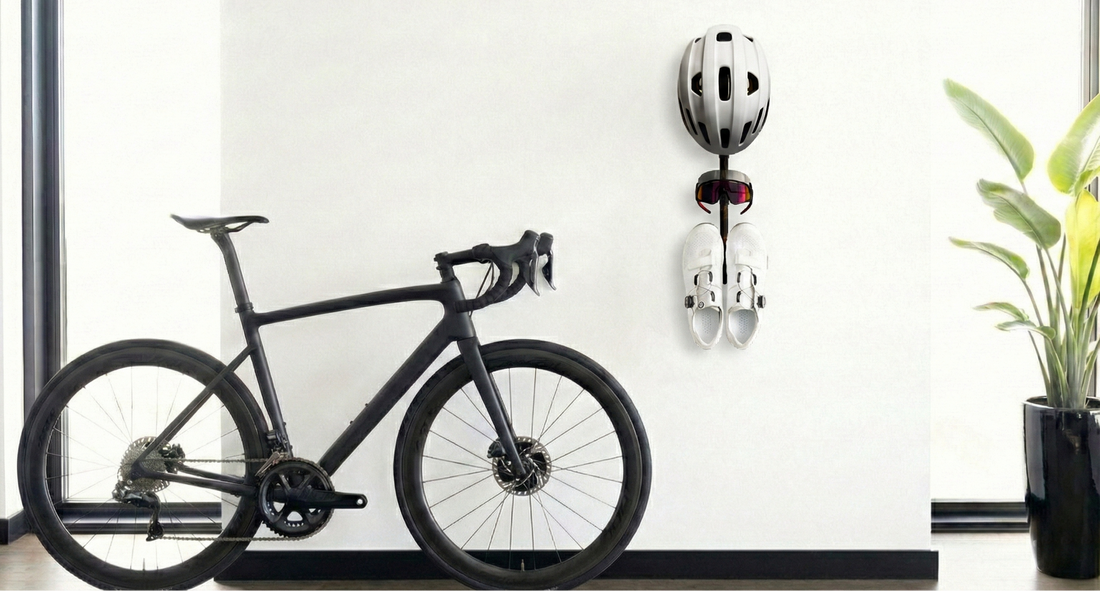 Wall-mounted cycling gear rack holding helmet, shoes, and sunglasses — MontaVelo Alta