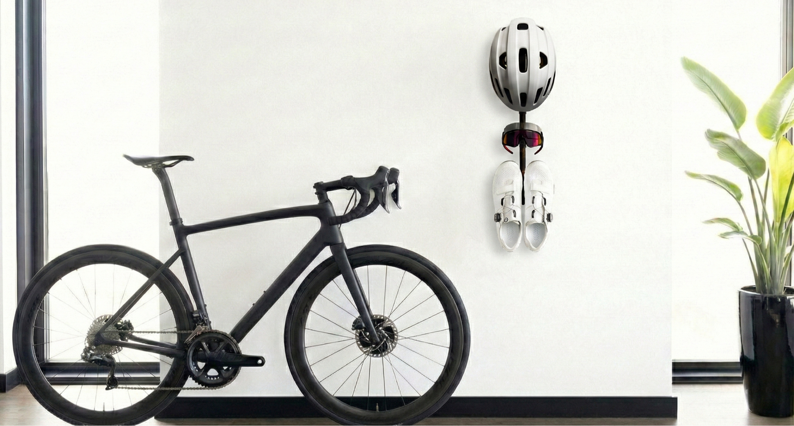 Wall-mounted cycling gear rack holding helmet, shoes, and sunglasses — MontaVelo Alta