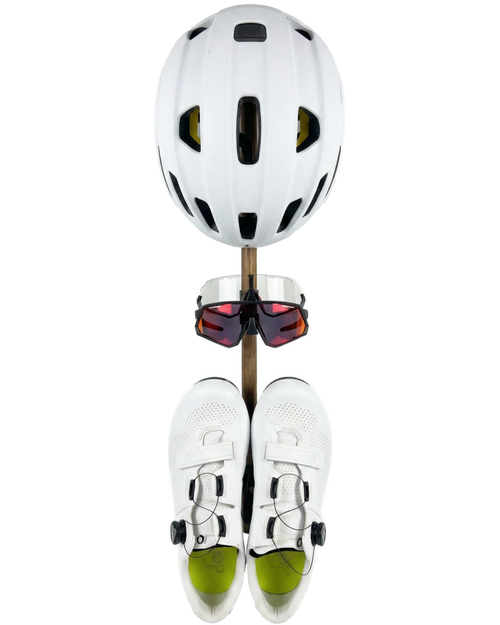 Product rack with a white helmet, two pairs of sunglasses, and a pair of white cycling shoes mounted on it. Viewed from the front.