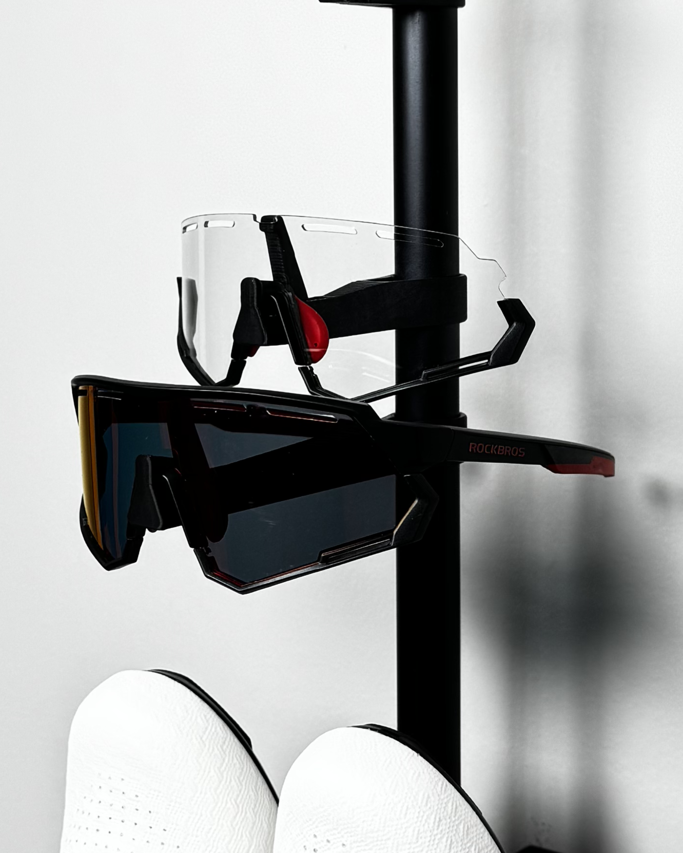 short and long glasses holders on rack, holding sunglasses