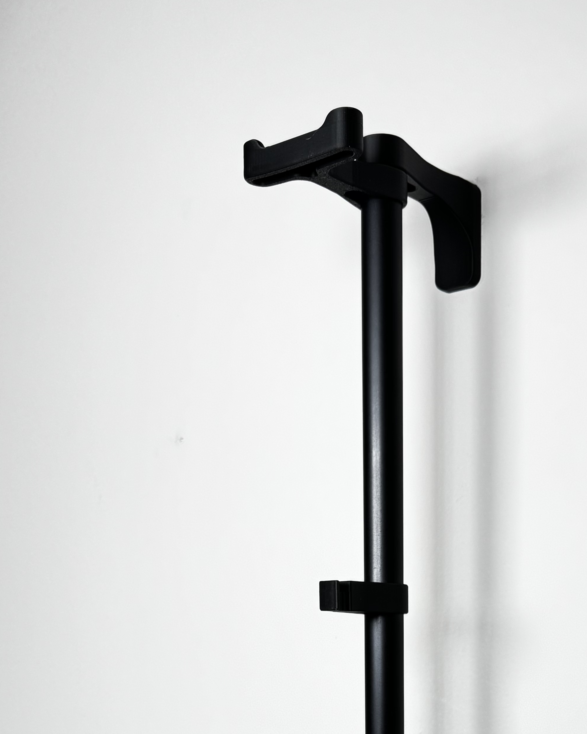 black plastic helmet holder on rack, empty