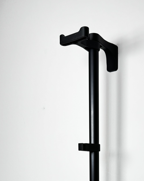 black plastic helmet holder on rack, empty